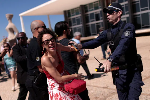 A woman clashes with police during a protest against rape and violence against women in Brasilia, Brazil, May 29, 2016. (Photo by Ueslei Marcelino/Reuters)