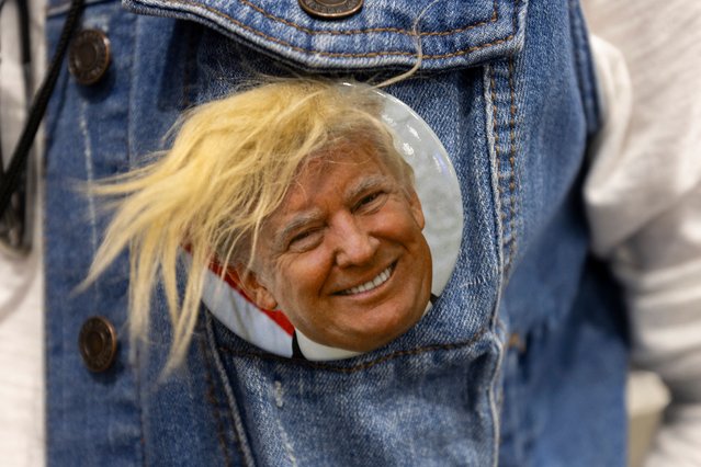 A woman wears a campaign pin at rally supporting former US President and Republican presidential candidate Donald Trump in Bozeman, Montana, on August 9, 2024. (Photo by Natalie Behring/AFP Photo)