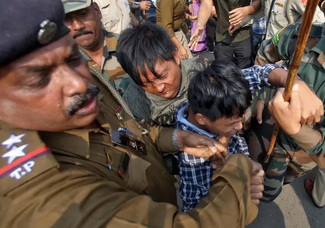Police officers try to detain demonstrators during a protest against the Citizenship Amendment Bill, that seeks to give citizenship to religious minorities persecuted in neighbouring Muslim countries, in Agartala, India, December 11, 2019. (Photo by Jayanta Dey/Reuters)