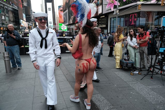 A sailor walks through Times Square during the start of the 35th annual Fleet Week on May 24, 2023 in New York City. Nine ships, including one each from Italy, the United Kingdom and Canada paraded into New York Harbor today for the start of the annual event which includes public ship tours, ceremonies and naval and military educational events. (Photo by Spencer Platt/Getty Images)