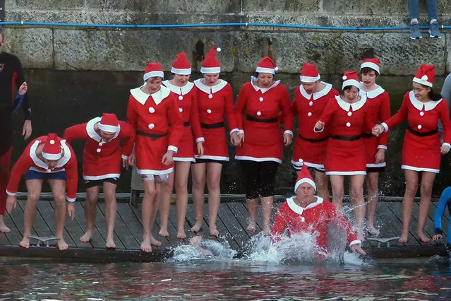 So many registered for the annual Weymouth Cross Harbour Christmas Day Swim in Dorset that the organisers (Lions Club) had to restrict the races to 50 at a times for health and safety reasons. 500 swimmers took part in the end. Thousands of spectators watched from the warmth of the quays sides on December 25, 2019. (Photo by Geoff Moore/Rex Features/Shutterstock)