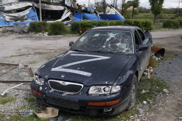 A destroyed vehicle with a letter Z is pictured in Ruska Lozova, a village retaken by the Ukrainian forces, amid Russia's attack on Ukraine, in Kharkiv region, Ukraine, May 15, 2022. (Photo by Ricardo Moraes/Reuters)