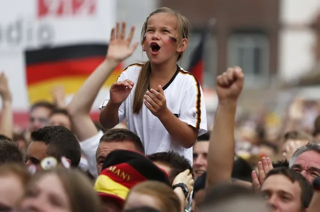 A girl celebrates a goal by Germany at a public viewing of the 2014 World Cup quarter-finals match between Germany and France in Dortmund July 4, 2014. (Photo by Ina Fassbender/Reuters)