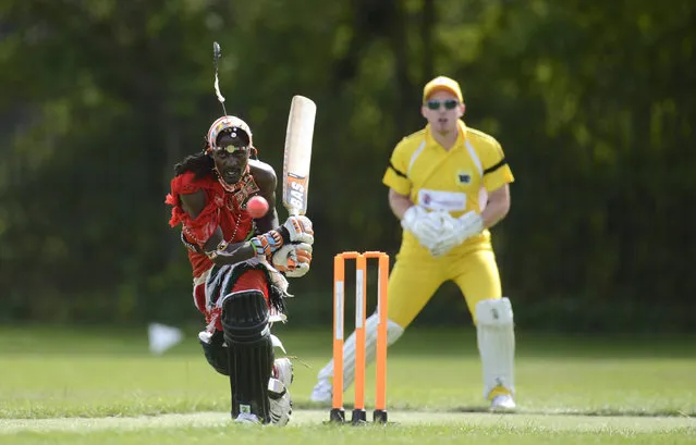 Nissan Jonathan Ole Meshami (L) of the Maasai Cricket Warriors team from Kenya hits the ball during a match against English team 'The Shed', during the “Last Man Stands” cricket tournament at Dulwich sports ground in South London September 1, 2013. (Photo by Philip Brown/Reuters)