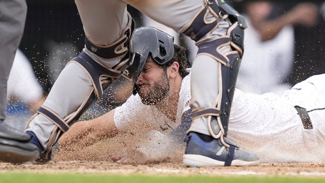 Detroit Tigers' Matt Vierling beats the throw to Tampa Bay Rays catcher Ben Rortvedt to score during the eighth inning of a baseball game, Thursday, September 26, 2024, in Detroit. (Photo by Carlos Osorio/AP Photo)