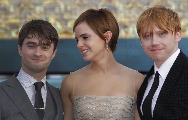 British actors, left to right, Daniel Radcliffe, Emma Watson and Rupert Grint, Trafalgar Square, in central London, for the World Premiere of “Harry Potter and the Deathly Hallows: Part 2” the last film in the series, Thursday, July 7, 2011. Harry Potter's saga is ending, but his magic spell remains. Thousands of fans from around the world massed in London Thursday for the premiere of the final film in the magical adventure series. (Photo by Joel Ryan/AP Photo)
