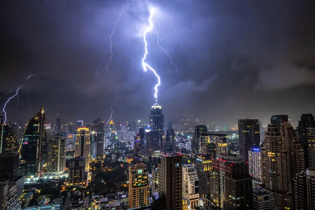 In this picture taken on October 27, 2019 lightening strikes on a building during a thunderstorm in Bangkok, Thailand. (Photo by Mladen Antonov/AFP Photo)