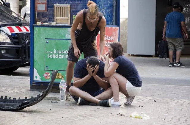 Injured people react after a van crashed into pedestrians in Las Ramblas, downtown Barcelona, Spain, 17 August 2017. (Photo by David Armengou/EPA/Rex Features/Shutterstock)