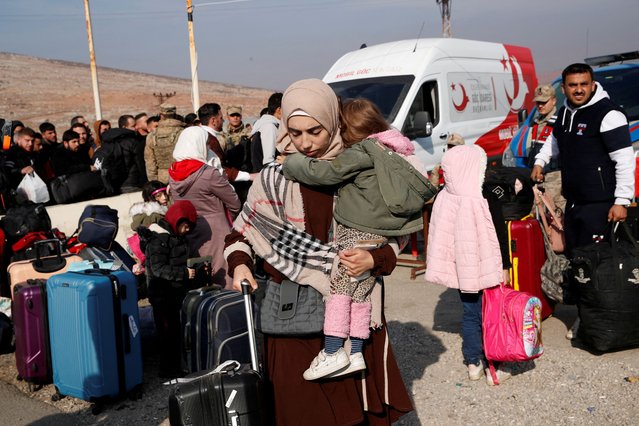 Syrian migrants wait at the Cilvegozu border gate to cross into Syria, after Syrian rebels announced that they have ousted Syria's Bashar al-Assad, in the Turkish town of Reyhanli in Hatay province, Turkey, on December 10, 2024. (Photo by Dilara Senkaya/Reuters)