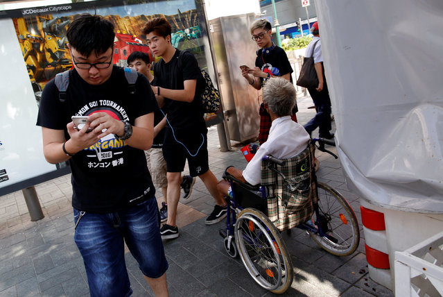 Participants take part in the world's first “Pokemon Go” competition in Hong Kong, China, August 6, 2016. (Photo by Tyrone Siu/Reuters)