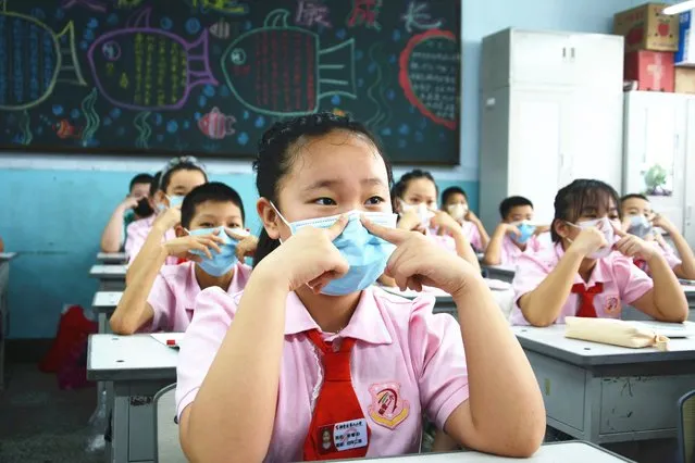 Students learn the correct way of wearing masks at a primary school in Jilin city in northeast China's Jilin province Monday, June 29, 2020, the first day of schooling after the prolonged coronavirus break.(Photo credit should read Feature China/Barcroft Media via Getty Images)