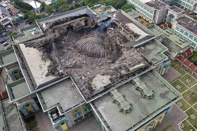 This aerial picture taken on October 20, 2022 shows the smouldering remains of the collapsed dome of the Islamic Centre mosque in Jakarta, which caught fire during ongoing renovation work. (Photo by Bagus Saragih/AFP Photo)