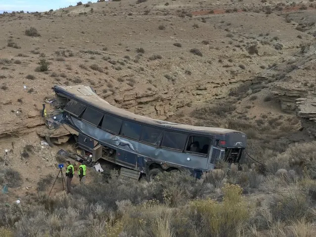 The aftermath of a late-Sunday Greyhound bus crash is seen on Monday, January 1, 2018 in Emery County. A 13-year-old girl died and 11 others were hospitalized when the bus went off the freeway and crashed into a steep wash. (Photo by Ben Tidswell/The Deseret News via AP Photo)