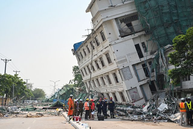 China's and Belarus' rescue teams coordinate at the site of a collapsed building in Mandalay on April 2, 2025, five days after a major earthquake struck central Myanmar. Days after a shallow 7.7-magnitude earthquake that killed more than 2,000 people, many people in Myanmar are still sleeping outdoors, either unable to return to ruined homes or afraid of further aftershocks. (Photo by AFP Photo/Stringer)
