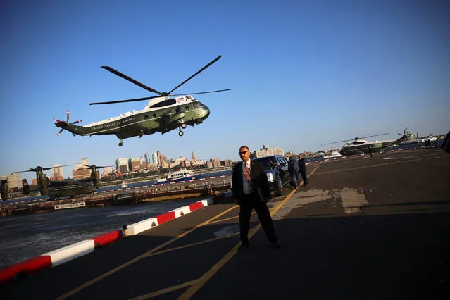 A Secret Service agent stands watch as U.S. President Barack Obama arrives aboard the Marine One helicopter at the Downtown Manhattan Heliport in New York, U.S. September 13, 2016. (Photo by Carlos Barria/Reuters)