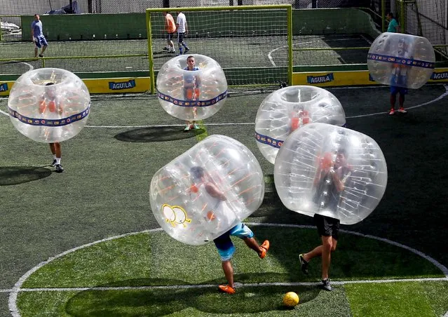 People take part in a game of 'bubble bump soccer' during an exhibition tournament in Medellin, Colombia, October 10, 2015. (Photo by Fredy Builes/Reuters)