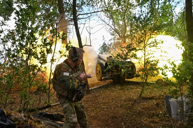 A service member of the 110th Separate Brigade of the Territorial Defence Forces of the Ukrainian Armed Forces fires a howitzer towards Russian troops, amid Russia's attack on Ukraine, at a front line in Zaporizhzhia region, Ukraine on June 16, 2025. (Photo by Reuters/Stringer)