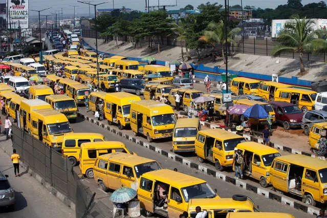 Commercial transport buses painted in yellow queue to take turn in collecting passengers at a motor park in Lagos, Nigeria, 10 September 2020. The price of petrol in Nigeria has been increased within the last three months from slightly above 121 naira($0.32) per liter in June to about 160 naira ($0.41) in September, with rising costs of transportation for commuters. Rights activists have been calling on the government for the reversal of the petrol pump price to no avail. (Photo by Akintunde Akinleye/EPA/EFE/Rex Features/Shutterstock)