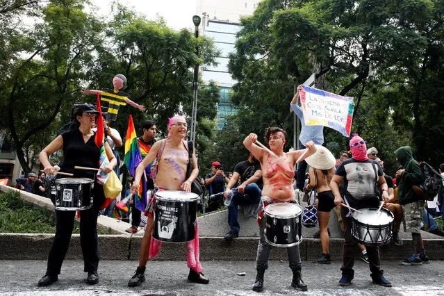 Participants play the drums at the Angel of Independence monument in support for the legalization of gay marriage while others protest against it and defend their interpretation of traditional family values, in Mexico City, Mexico September 24, 2016. (Photo by Carlos Jasso/Reuters)