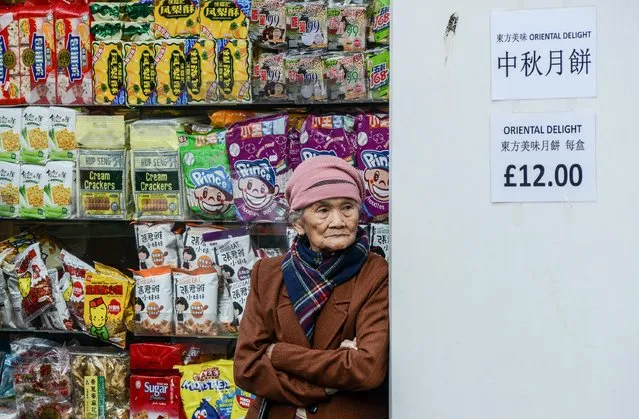 An elderly Chinese woman stands outside a local supermarket in Chinatown on October 20, 2015 in London, England. The President of the People's Republic of China and his wife are currently paying a State visit to the United Kingdom as guests of The Queen. (Photo by Chris Ratcliffe/Getty Images)