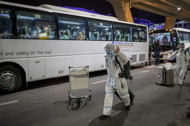A bus leaves with Chinese tourists from Shanghai, who arrived at Suvarnabhumi airport on special tourist visas, in Bangkok, Thailand, Tuesday, October 20, 2020. Thailand on Tuesday took a modest step toward reviving its coronavirus-battered tourist industry by welcoming 39 visitors who flew in from Shanghai, the first such arrival since normal traveler arrivals were banned almost seven months ago. (Photo by Wason Wanichakorn/AP Photo)