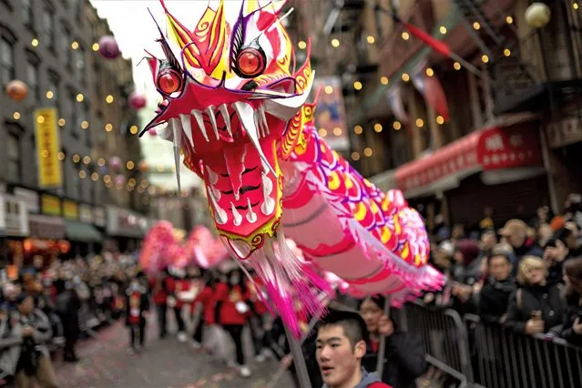 Revelers celebrate Lunar New Year in Manhattan's Chinatown, Sunday, February 12, 2023, in New York. (Photo by John Minchillo/AP Photo)