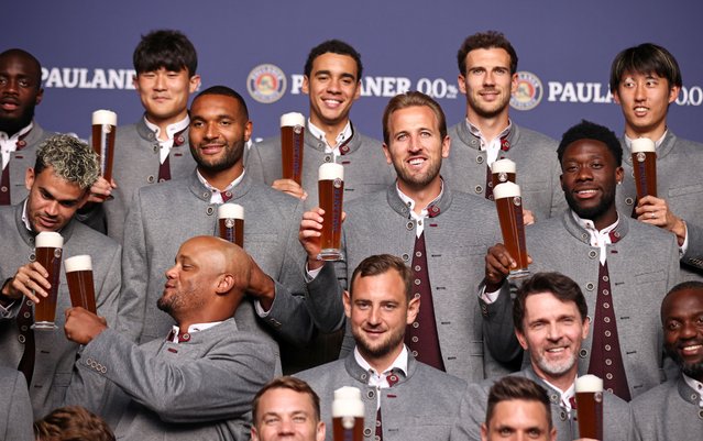Harry Kane, centre, poses with Bayern Munich teammates including Luis Díaz and Alphonso Davies, and the club’s manager, Vincent Kompany, for a traditional photoshoot in lederhosen before the annual Oktoberfest beer festival in Munich on August 19, 2025. (Photo by Stefan Matzke/Bayern Munich and Paulaner/Handout via Reuters)