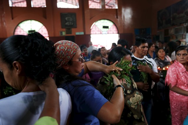 A woman receives a traditional cleansing in the church of San Simon in Iztapa, Chimaltenango, Guatemala, October 28, 2015. (Photo by Jorge Dan Lopez/Reuters)