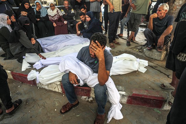 Relatives mourn near covered bodies at Al Shifa hospital after members of their family were killed in an Israeli airstrike, in Gaza City, Gaza Strip, 29 August 2025. According to the Palestinian Ministry of Health in Gaza, six members of a family were killed on 28 August after an Israeli airstrike hit the west of Jabaliya refugee camp, north of Gaza City. (Photo by Mohammed Saber/EPA)