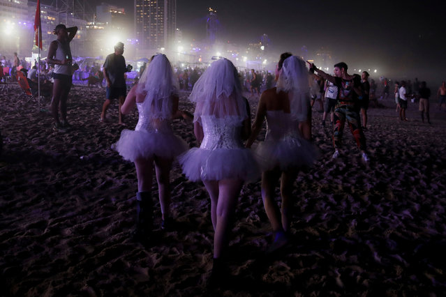 Fans dressed as brides walk as people crowd at Copacabana beach to attend Madonna's free concert in Rio de Janeiro, Brazil, on May 4, 2024. (Photo by Lucas Landau/Reuters)