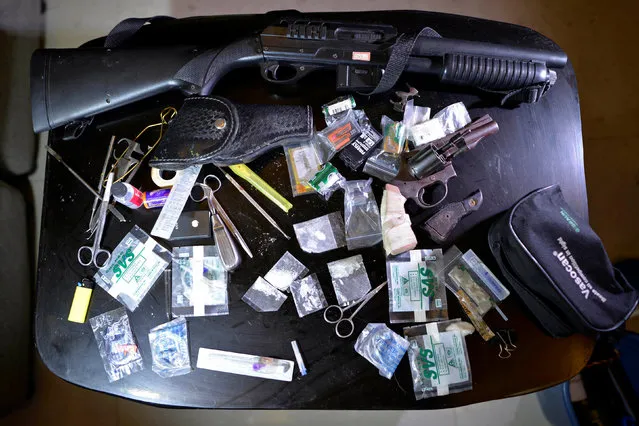 Weapons, shabu (Metamphetamine Hydrochloride) and other drug paraphernalia are pictured inside a house after a drug buy bust operation in Quezon city, Metro Manila, Philippines, October 18, 2016. (Photo by Ezra Acayan/Reuters)