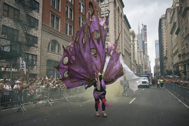 A reveler marches along Fifth Avenue during the Pride March, in New York, June 30, 2024. (Photo by Andres Kudacki/AP Photo)