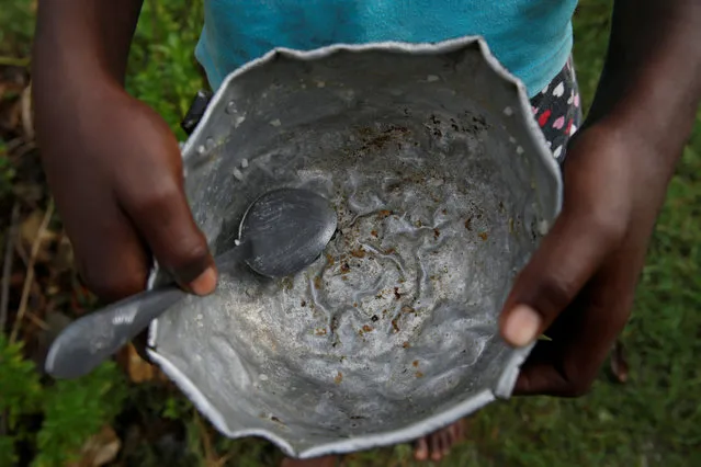 A girl holds a bowl, after Hurricane Matthew hit Jeremie, Haiti, October 19, 2016. (Photo by Carlos Garcia Rawlins/Reuters)