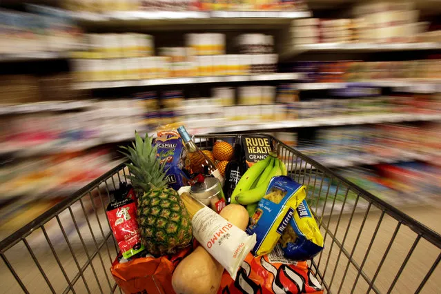 A shopping trolley is pushed around a supermarket in London, Britain, May 19, 2015. (Photo by Stefan Wermuth/Reuters)