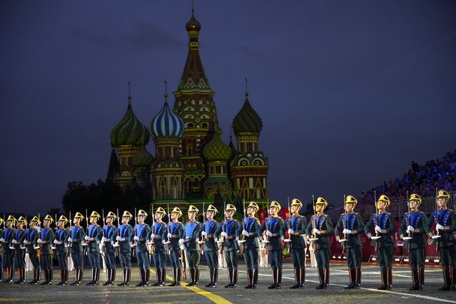 Presidential regiment soldiers perform during the Spasskaya Tower International Military Music Festival in Red Square, backdropped by the St. Basil Cathedral, in Moscow, August 23, 2024. (Photo by Alexander Zemlianichenko/AP Photo)