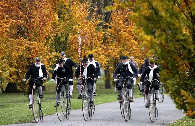 Enthusiasts dressed in historical costumes enjoy a ride on high-heel bicycles during their traditional meeting in Prague, Czech Republic, Saturday, November 5, 2016. (Photo by Petr David Josek/AP Photo)