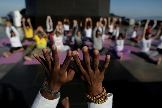 People perform yoga on International Yoga Day in Rio de Janeiro, Brazil on June 21, 2018. (Photo by Bruno Kelly/Reuters)