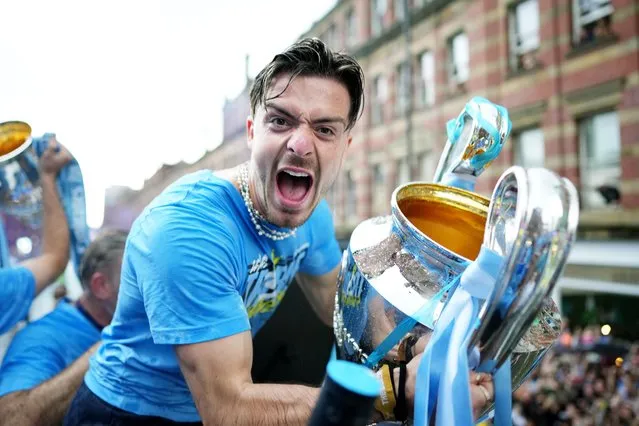 Jack Grealish of Manchester City celebrates with the UEFA Champions League Trophy on the Open-Top Bus during the Manchester City trophy parade on June 12, 2023 in Manchester, England. (Photo by Tom Flathers/Manchester City FC via Getty Images)