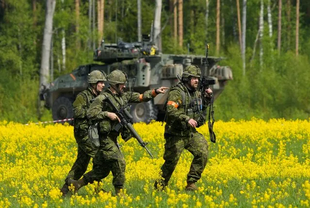 Canadian troops of NATO enhanced Forward Presence battlegroup run during Namejs 2022 military exercise near Strenci, Latvia on May 22, 2022. (Photo by Ints Kalnins/Reuters)