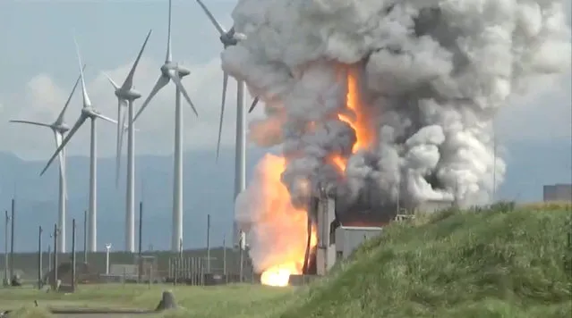 Smoke rises following the explosion of a rocket engine during a test in Noshiro City, Akita Prefecture, Japan, July 14, 2023, in this screengrab taken from a handout video. (Photo by NVS-LIVE.COM/Handout via Reuters)