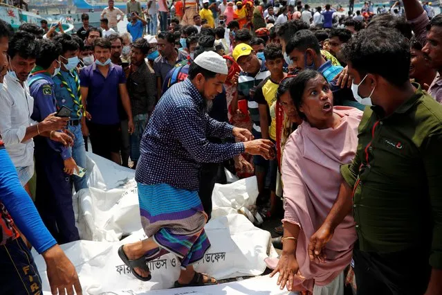 Relatives identify victim's bodies recovered from a ferry that collided with a cargo vessel and sank on Sunday in the Shitalakhsyaa River, in Narayanganj, Bangladesh, April 5, 2021. (Photo by Mohammad Ponir Hossain/Reuters)