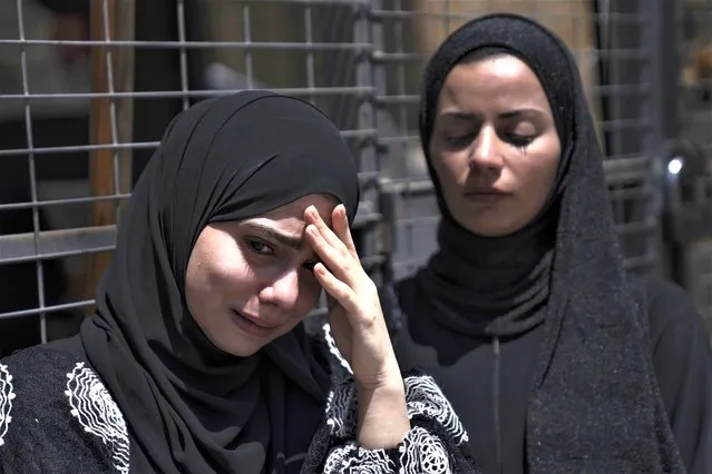 Mourners cry during the funeral of Mahmoud Jarad, 23, in the West Bank city of Tulkarem, Friday, August 11, 2023. The Israeli military stormed into a refugee camp in the northern occupied West Bank on Friday, sparking a firefight with Palestinian gunmen and killing the 23-year-old militant, Palestinian authorities said. (Photo by Nasser Nasser/AP Photo)