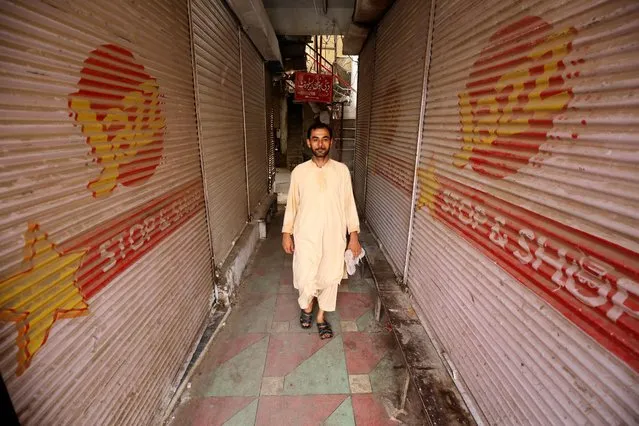 A man walks along closed market stalls after traders called for a shutter down strike to protest against the inflation in Peshawar, Pakistan, 31 August 2023. Protests against inflated electricity bills have erupted in several cities across Pakistan, with demonstrators torching their monthly bills, and trade leaders and representatives expressing concerns about excessive charges. People struggling to make ends meet have been hit hard by high electricity bills, and the government's failure to reduce prices and additional taxes is a major issue. The promises of cheap electricity made during privatization have not been fulfilled, leading traders and the general public to demand a reduction in prices and taxes. (Photo by Bilawal Arbab/EPA/EFE)