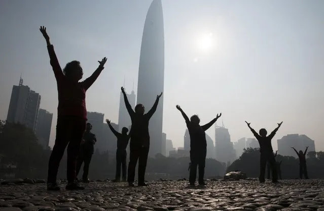 Residents do morning exercises at a park on a hazy day in Shenzhen, Guangdong province February 12, 2015. Nearly 90 percent of China's big cities failed to meet air quality standards in 2014, but that was still an improvement on 2013 as the country's “war on pollution” began to take effect, the environment ministry said on February 2. (Photo by Reuters/Stringer)
