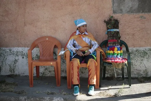 A reveller waits for the start of a parade during a feast in honour of Saint Sebastian, patron saint of Diriamba, in Diriamba, Nicaragua January 19, 2016. (Photo by Oswaldo Rivas/Reuters)