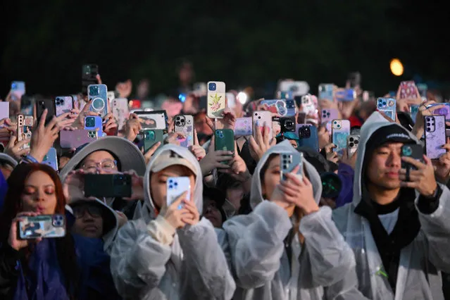 Fans record with their phones as South Korean singer Jungkook performs onstage during the Global Citizen Festival at Central Park in New York City on September 23, 2023. (Photo by Angela Weiss/AFP Photo)