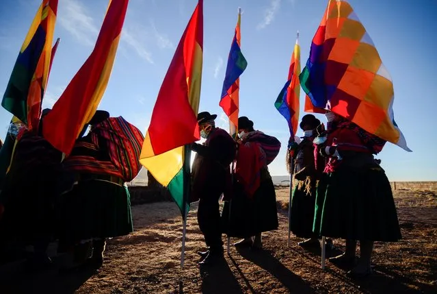 People attend an ancestral ceremony to ring in the Aymara New Year, in Tiwanaku, Bolivia on June 21, 2021. (Photo by Claudia Morales/Reuters)
