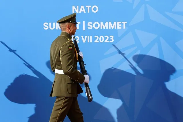 A member of the Lithuanian army walks at the presidential palace ahead of a dinner hosted by Lithuanian President Gitanas Nauseda during a NATO leaders summit in Vilnius, Lithuania on July 11, 2023. (Photo by Yves Herman/Reuters)