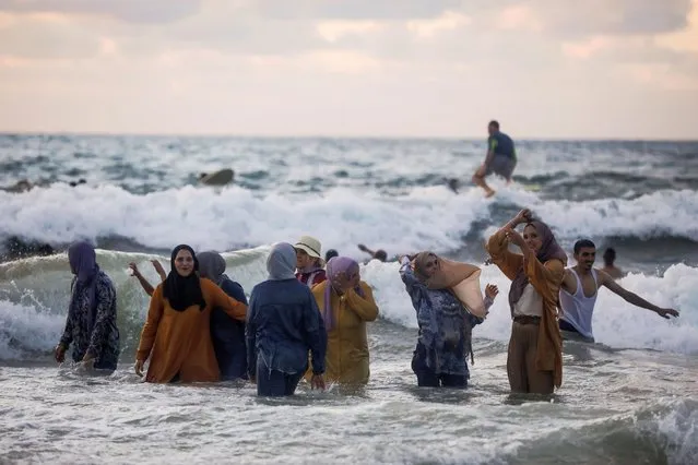 People enjoy themselves as they bathe in the Mediterranean Sea during the Muslim holiday of Eid al-Adha in Tel Aviv, Israel on July 21, 2021. (Photo by Nir Elias/Reuters)