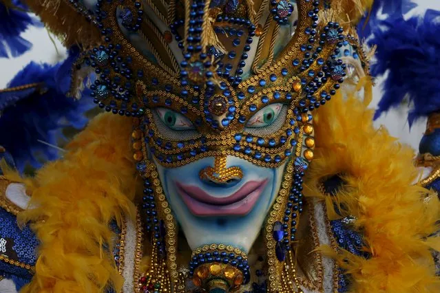 A reveller wearing a mask takes part in the last day of the annual Carnival parade in Panama City February 9, 2016. (Photo by Carlos Jasso/Reuters)